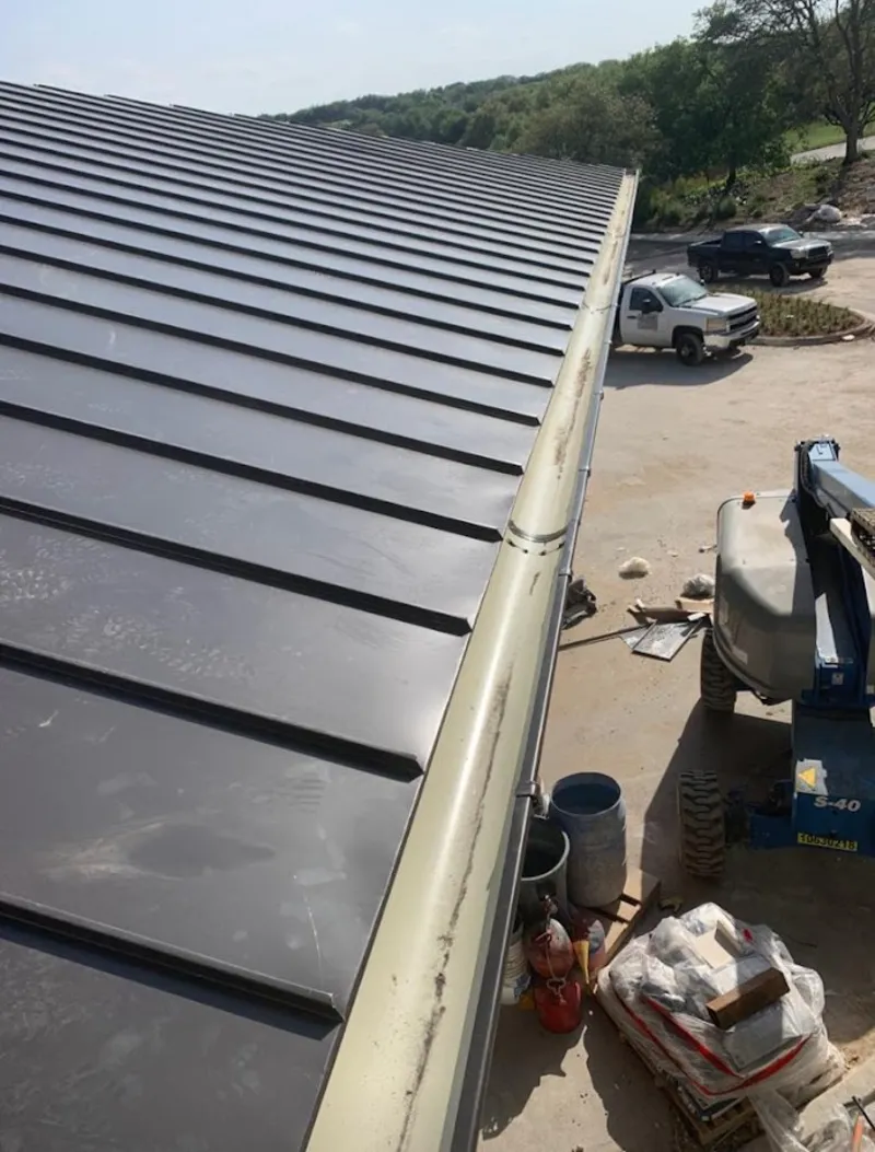 Standing seam panel and gutter detail on a metal roofing jobsite in Summit